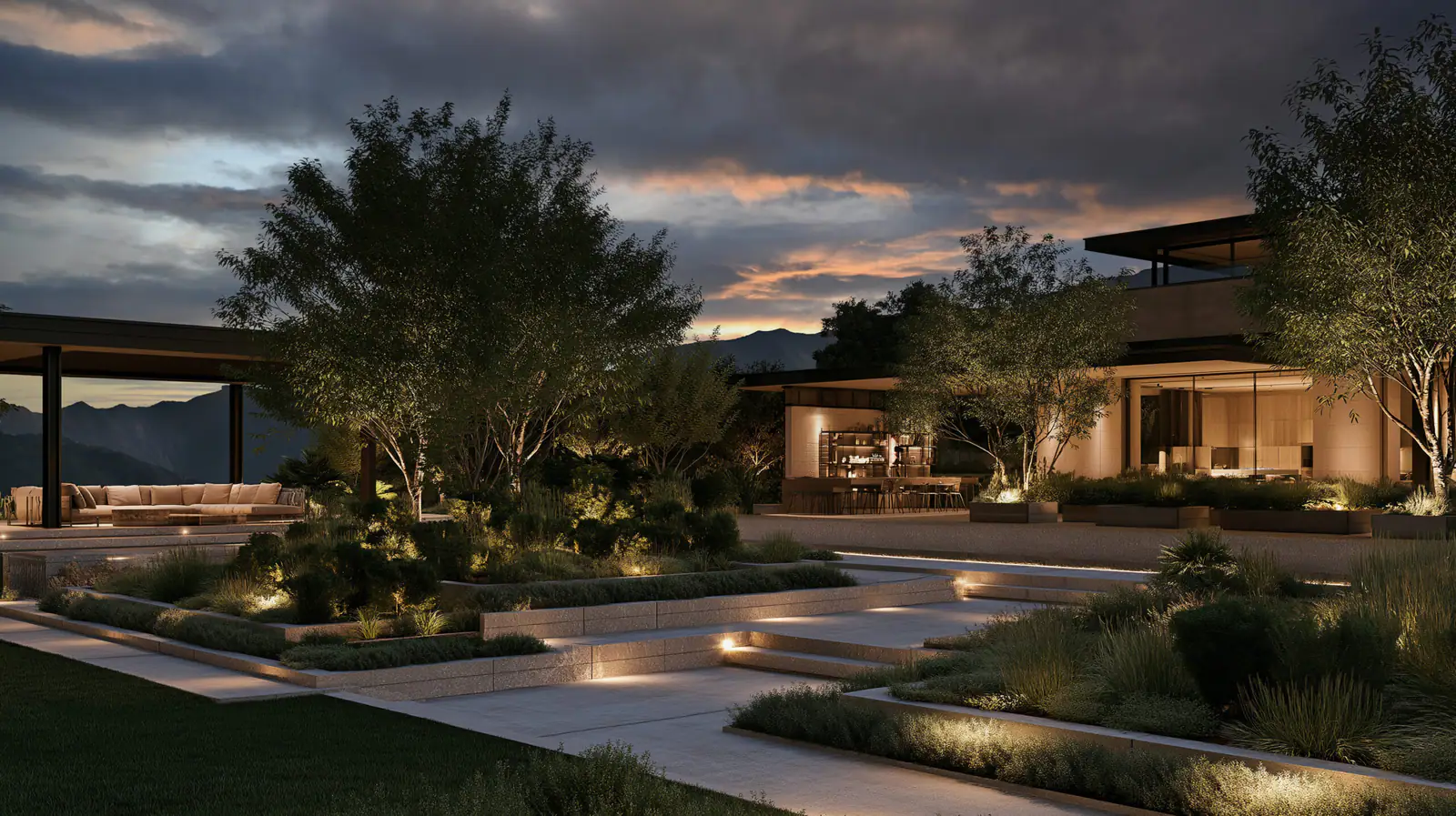 A modern estate at dusk, its stepped terraces, trees and lawns softly lit